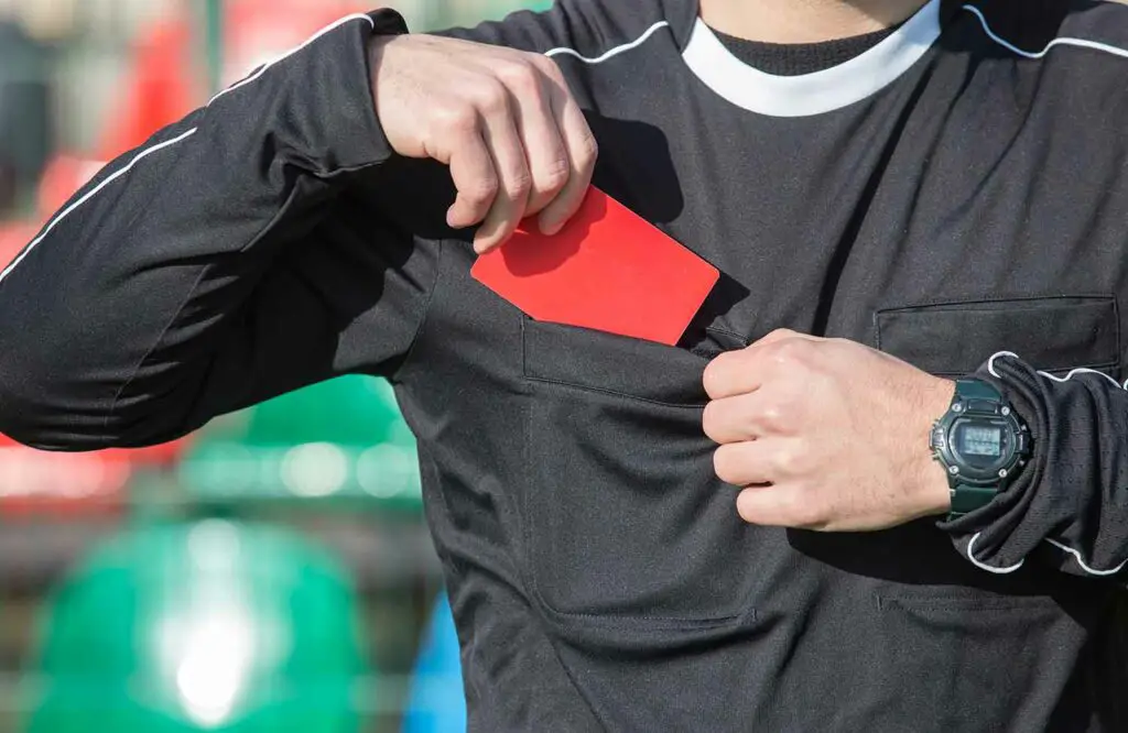 soccer ref giving red card to player