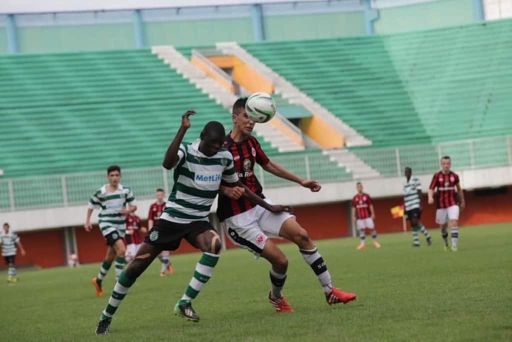 Two soccer players trying to win the ball