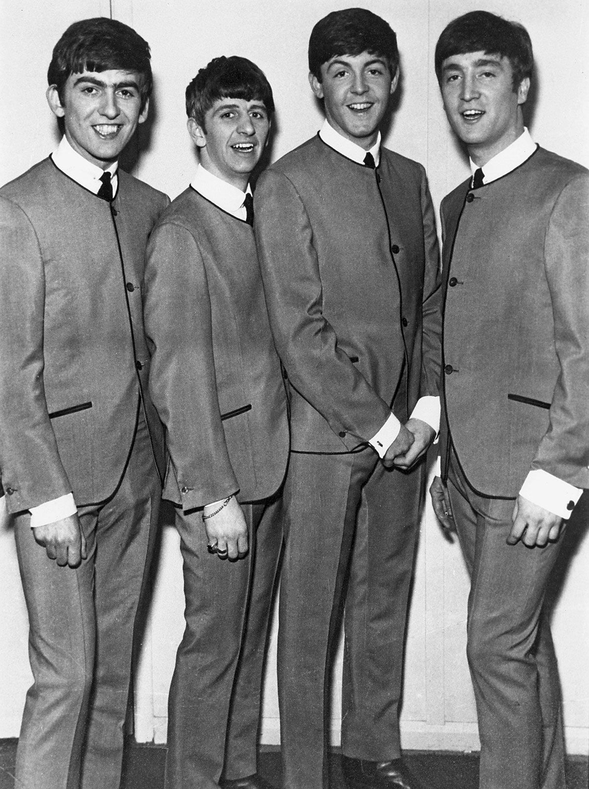 Teamwork shines in iconic beatles group photo capturing legends